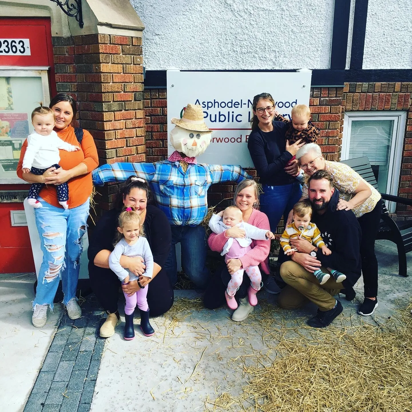 Children and adults gathered outside the library for a fall celebration