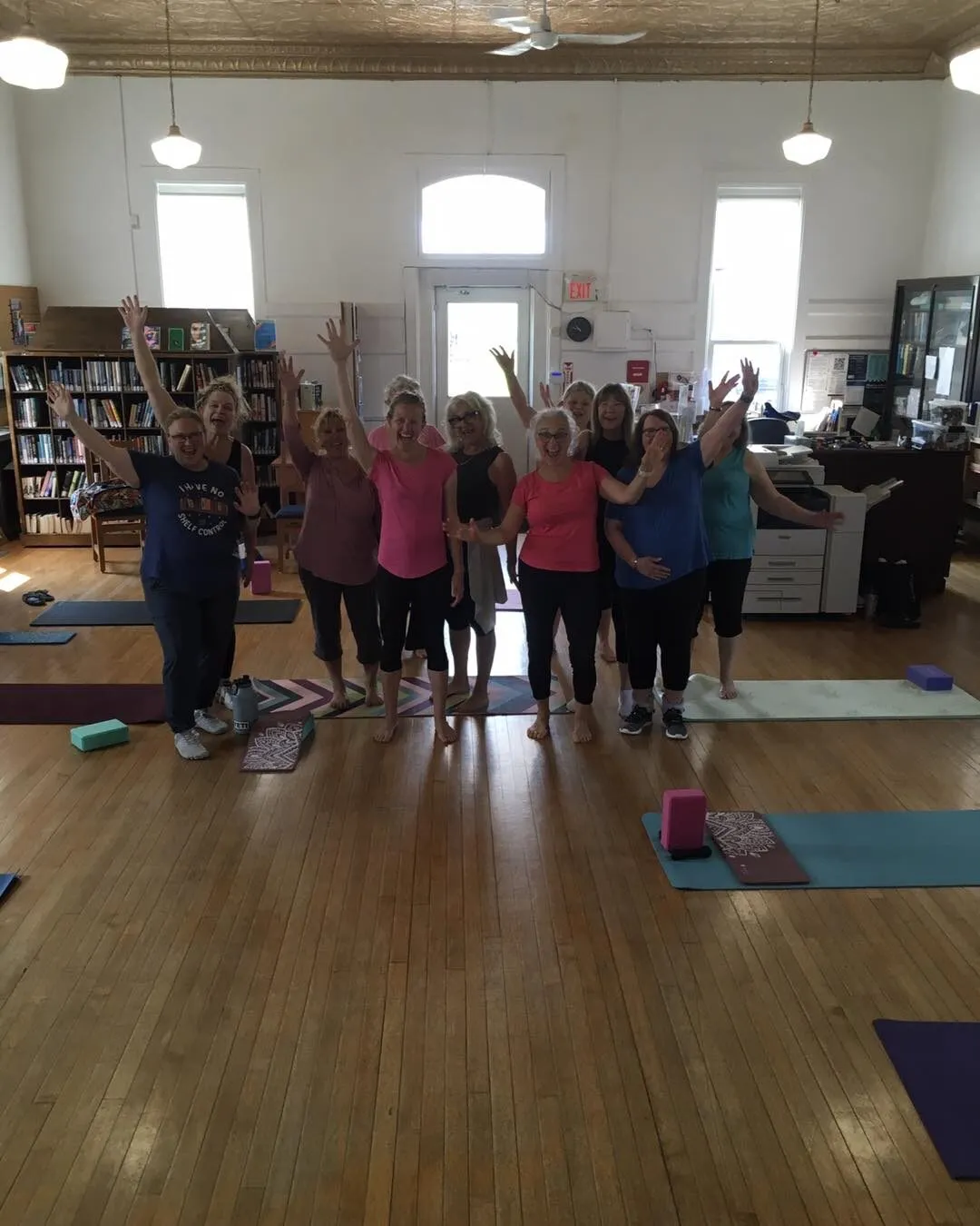 Adults participating in a yoga class in a library community space